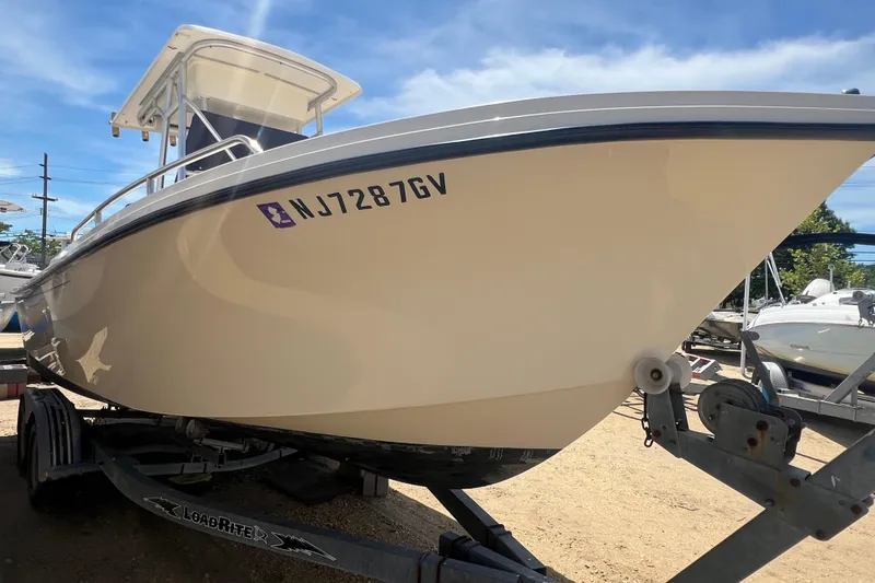 Slide: The Image of 2004 Parker 2300 Special Edition boat on trailer, side view with registration number NJ7287GV. - 1