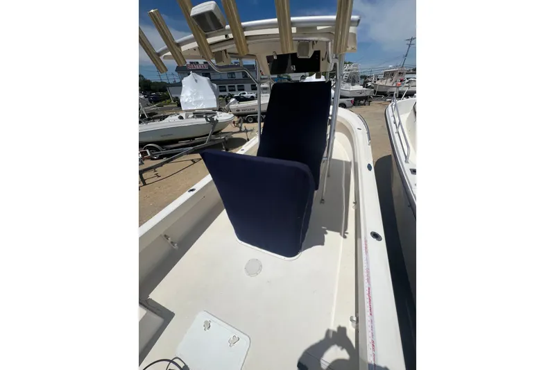 Slide: The Image of 2004 Parker 2300 Special Edition boat with blue seating, docked outdoors. - 3