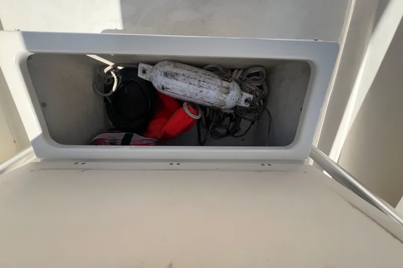 Slide: The Image of Storage compartment on a 2004 Parker 2300 Special Edition boat with ropes and equipment. - 8