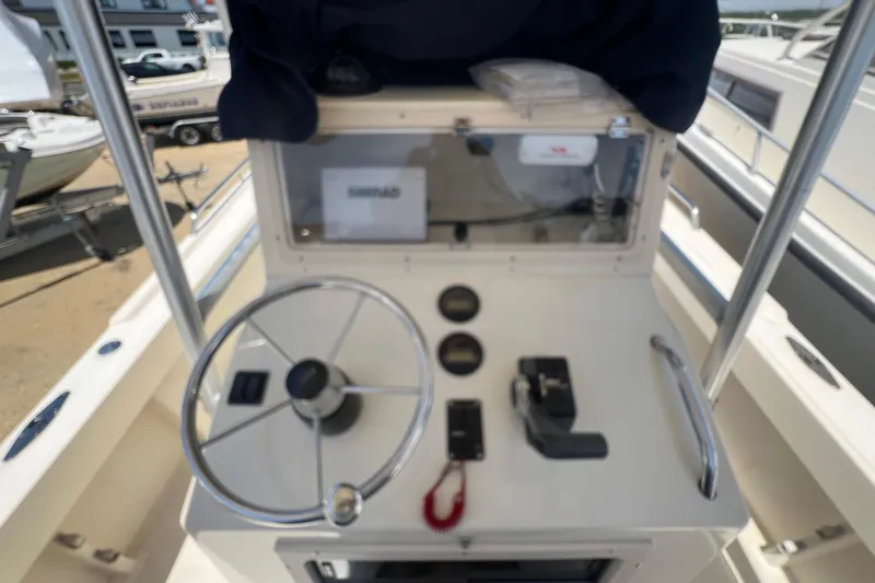 Slide: The Image of 2004 Parker 2300 Special Edition boat console with steering wheel and controls. - 9