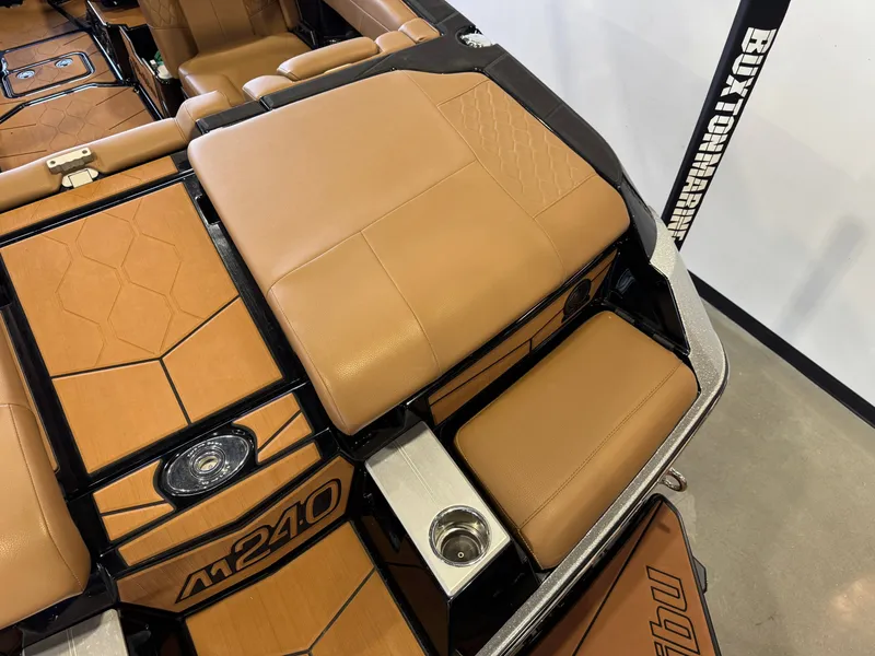 Slide: The Image of Interior of a 2021 Malibu M240 boat with brown leather seats. - 10