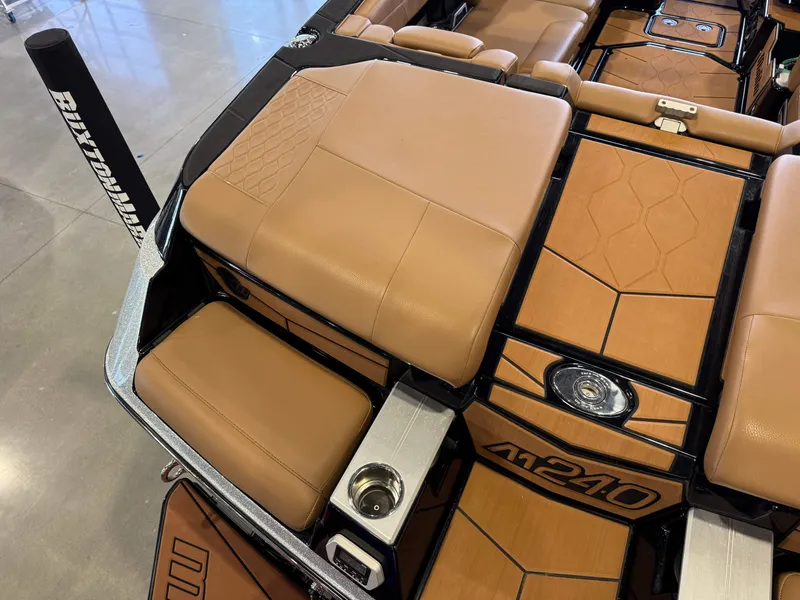 Slide: The Image of Interior of a 2021 Malibu M240 boat with brown leather seats. - 11