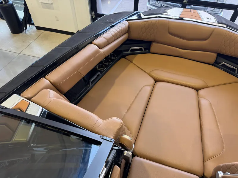 Slide: The Image of Interior of a 2021 Malibu M240 boat with brown leather seating. - 17