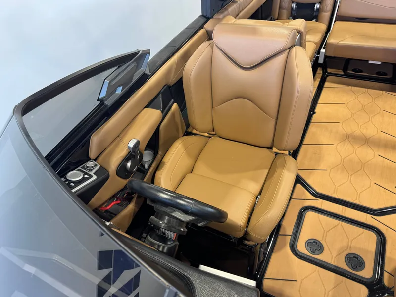 Slide: The Image of Interior of a 2021 Malibu M240 boat with brown leather seats. - 19