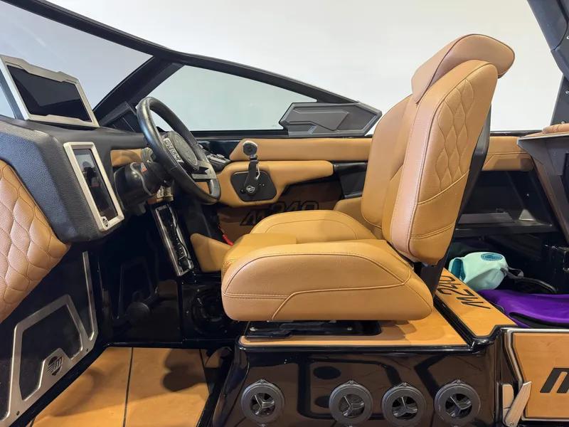 Slide: The Image of Interior of a 2021 Malibu M240 boat with luxurious leather seats. - 21