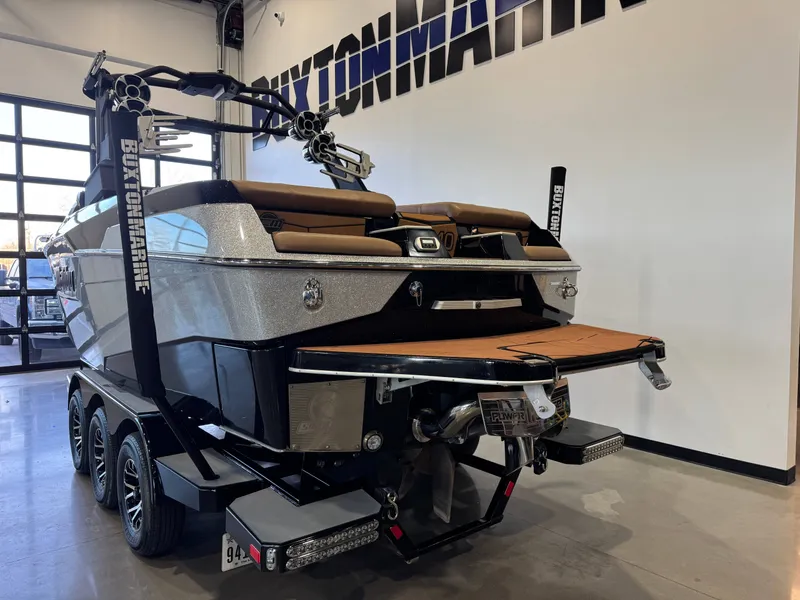Slide: The Image of 2021 Malibu M240 boat on trailer in showroom. - 4