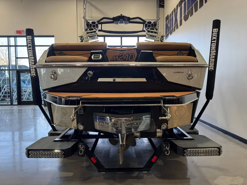 Slide: The Image of Rear view of a 2021 Malibu M240 boat in showroom. - 5