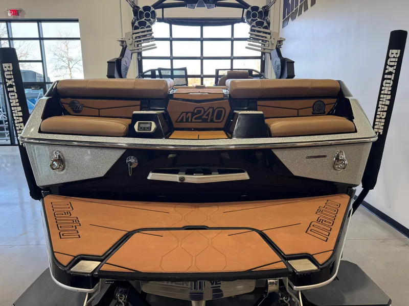 Slide: The Image of Rear view of a 2021 Malibu M240 boat in showroom. - 7