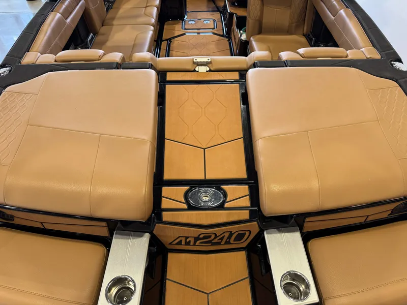 Slide: The Image of Interior of a 2021 Malibu M240 boat with brown leather seating. - 9