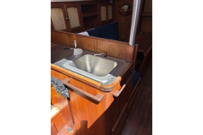 Slide: The Image of Interior of 1979 Aloha 34 sailboat featuring a wooden kitchenette with a sink. - 18