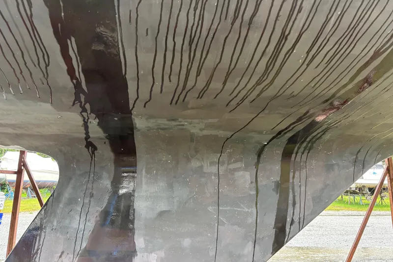 Slide: The Image of Close-up of a 1979 Aloha 34 boat hull with streaks and reflections. - 2
