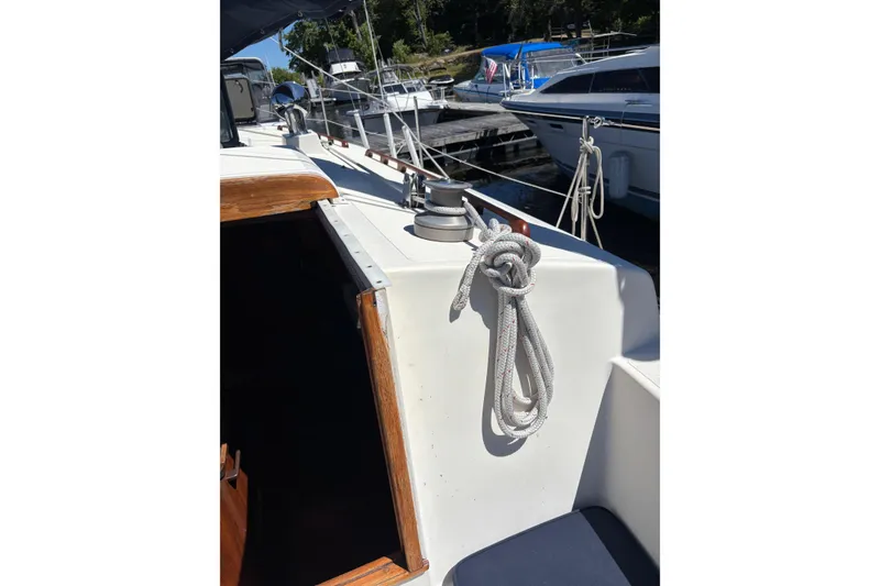 Slide: The Image of 1979 Aloha 34 sailboat deck with coiled rope, docked at marina. - 28