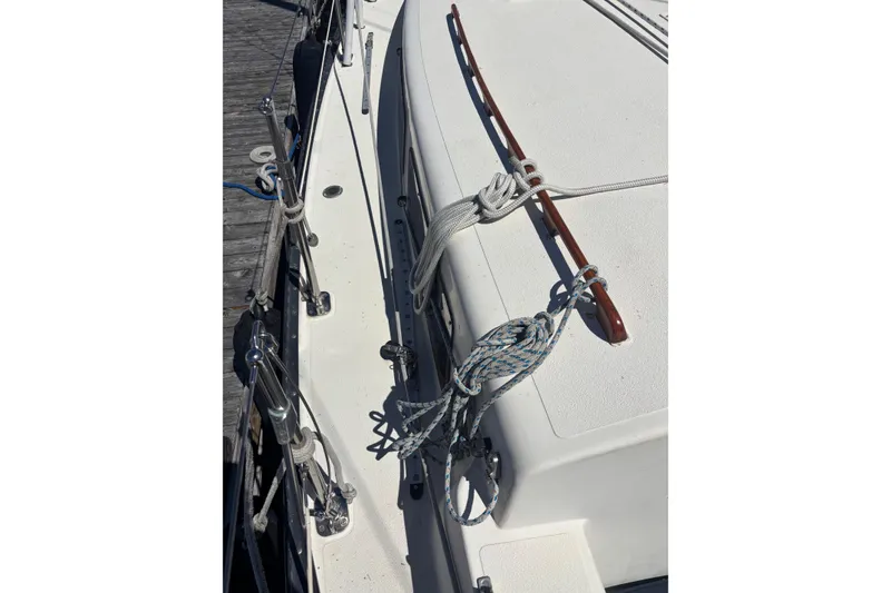 Slide: The Image of 1979 Aloha 34 sailboat deck with ropes and wooden handrail. - 31