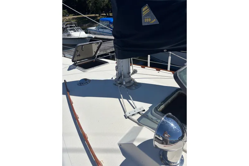 Slide: The Image of 1979 Aloha 34 sailboat deck with open hatch and rigging details. - 34