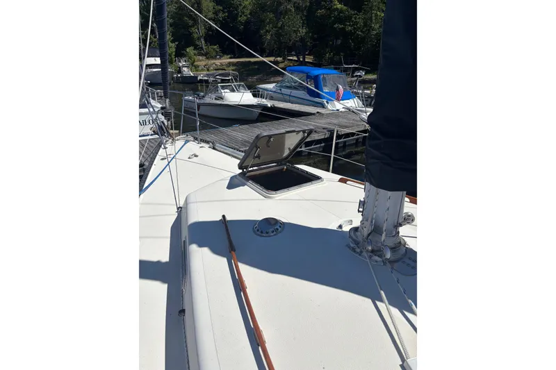 Slide: The Image of Sailboat deck view of a 1979 Aloha 34, docked with open hatch. - 35