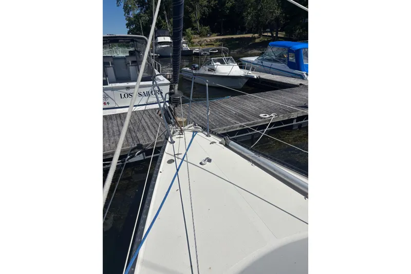 Slide: The Image of 1979 Aloha 34 sailboat docked at marina with other boats in background. - 36