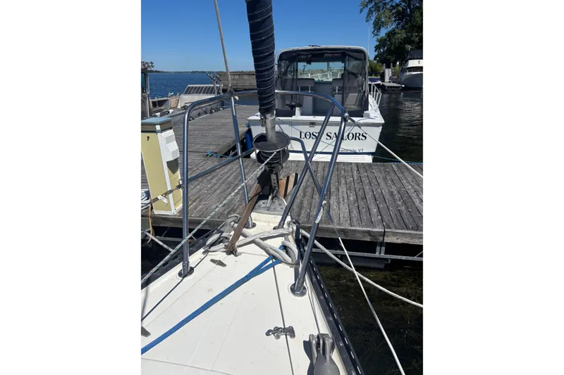 Slide: The Image of 1979 Aloha 34 sailboat docked, featuring deck and rigging details. - 37