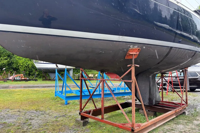 Slide: The Image of 1979 Aloha 34 sailboat on stands, displayed outdoors on a grassy area. - 4