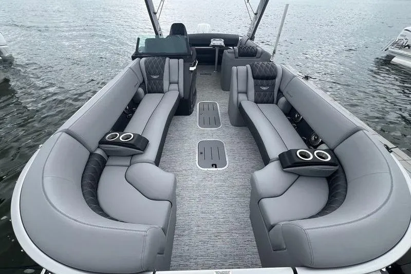 Slide: The Image of Luxurious 2026 Bennington RX 25 RXSBA pontoon boat interior with plush seating on water. - 9