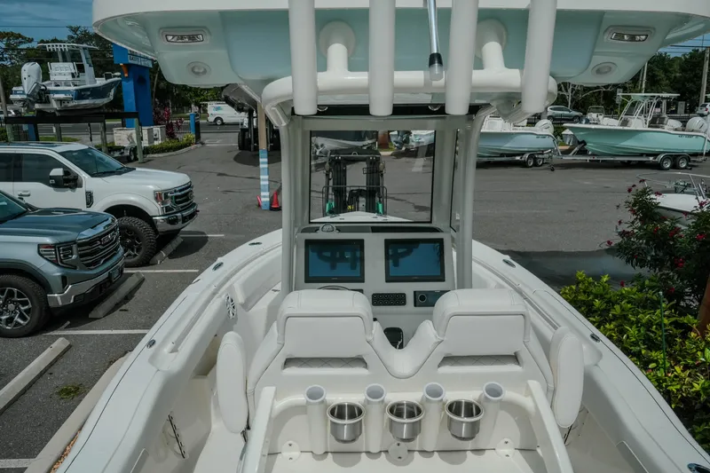 Slide: The Image of 2026 Key West 239 FSR boat interior with dual screens and cup holders. - 19