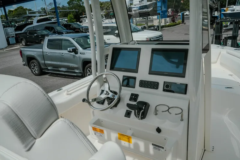 Slide: The Image of Helm of 2026 Key West 239 FSR boat with modern controls and dual screens. - 22