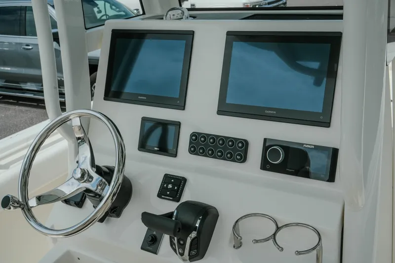 Slide: The Image of Helm of 2026 Key West 239 FSR boat with dual Garmin displays and steering wheel. - 23