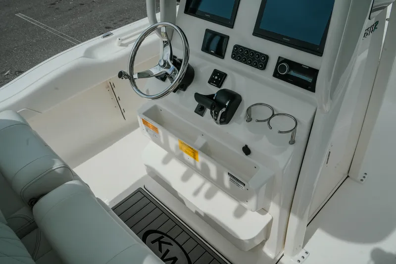 Slide: The Image of 2026 Key West 239 FSR boat cockpit with steering wheel and control panel. - 24