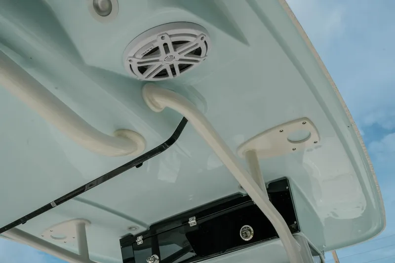 Slide: The Image of 2026 Key West 239 FSR boat roof with speaker and rod holders against blue sky. - 25