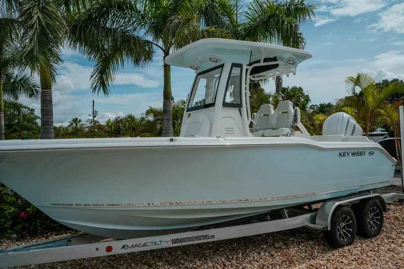 Slide: The Image of 2026 Key West 239 FSR boat on trailer, surrounded by palm trees. - 3
