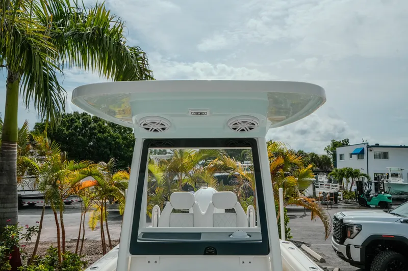 Slide: The Image of 2026 Key West 239 FSR boat with speakers, surrounded by tropical palm trees. - 33