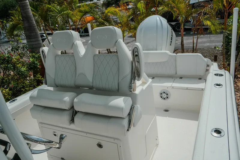 Slide: The Image of 2026 Key West 239 FSR boat interior with white seating and lush greenery background. - 35