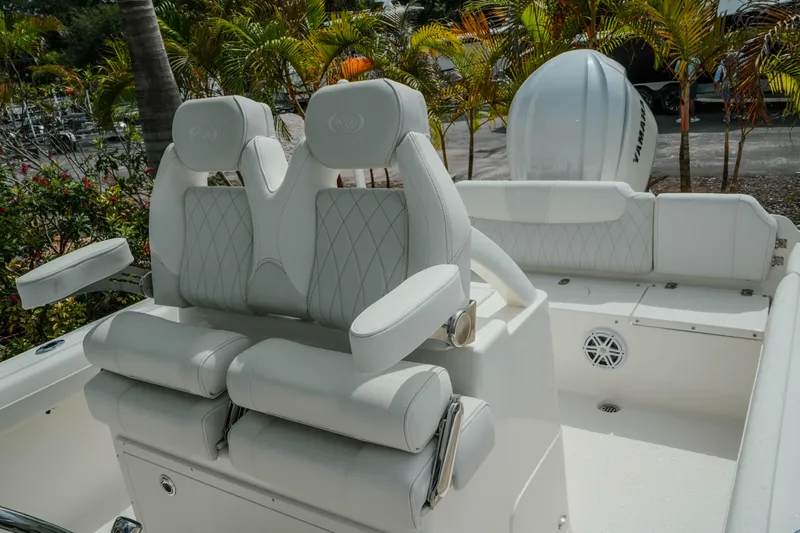 Slide: The Image of Luxurious seating on 2026 Key West 239 FSR boat with white upholstery and palm trees. - 37