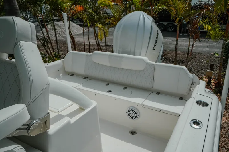 Slide: The Image of 2026 Key West 239 FSR boat interior with Yamaha engine, featuring white seating and cup holders. - 38