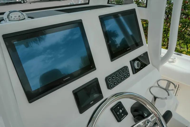 Slide: The Image of Helm of 2026 Key West 239 FSR boat with dual Garmin displays and steering wheel. - 39