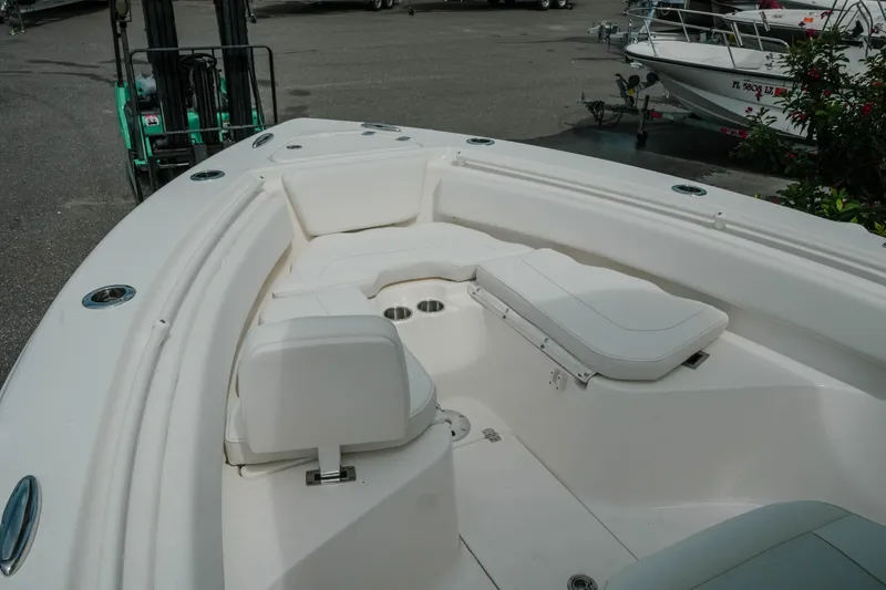Slide: The Image of 2026 Key West 239 FSR boat with spacious seating and sleek design in a marina setting. - 40