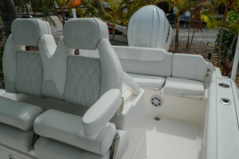 Slide: The Image of 2026 Key West 239 FSR boat interior with white cushioned seating and sleek design. - 41