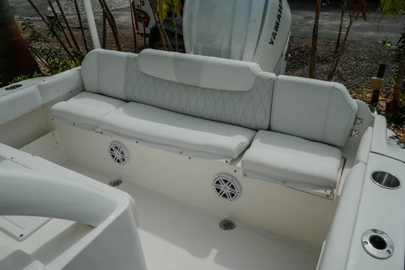 Slide: The Image of 2026 Key West 239 FSR boat interior with cushioned seating and speaker system. - 42