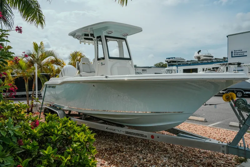 Slide: The Image of 2026 Key West 239 FSR boat on trailer, surrounded by tropical plants. - 6