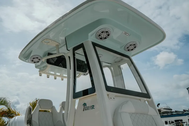 Slide: The Image of 2026 Key West 239 FSR boat with speakers and seating under a cloudy sky. - 7