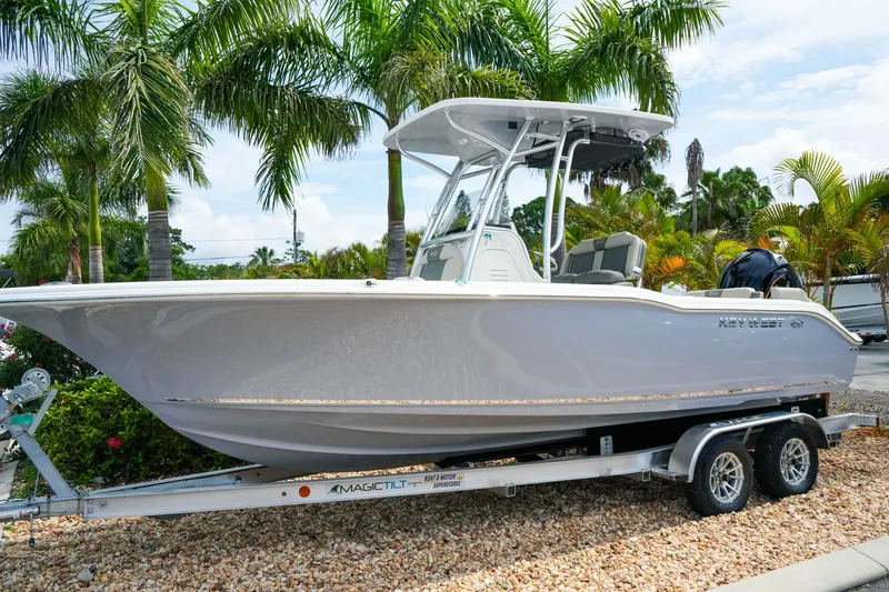 The Image of 2026 Key West 239 FS boat on trailer, surrounded by palm trees. - 1