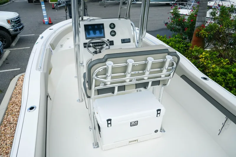 Slide: The Image of 2026 Key West 239 FS boat interior with steering console and rod holders. - 12