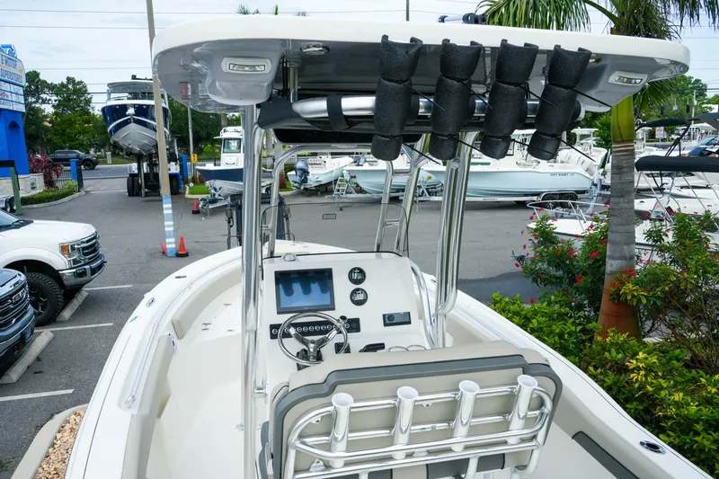 Slide: The Image of 2026 Key West 239 FS boat with modern console and seating in a marina setting. - 13