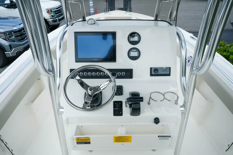 Slide: The Image of 2026 Key West 239 FS boat dashboard with steering wheel and electronic controls. - 17