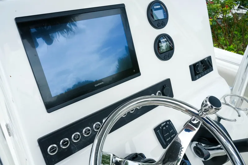 Slide: The Image of 2026 Key West 239 FS boat dashboard with Garmin display and Yamaha gauges. - 22