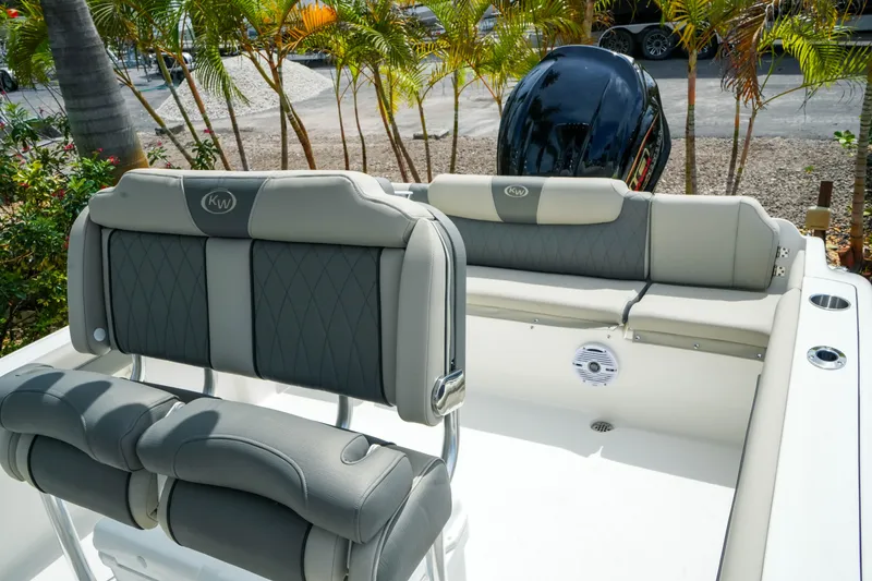 Slide: The Image of 2026 Key West 239 FS boat interior with cushioned seating and outboard motor. - 24