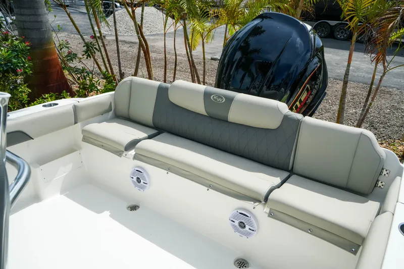 Slide: The Image of 2026 Key West 239 FS boat interior with cushioned seating and outboard motor. - 25