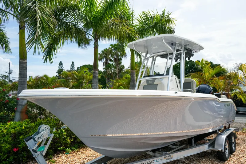 Slide: The Image of 2026 Key West 239 FS boat on trailer, surrounded by tropical palm trees. - 3