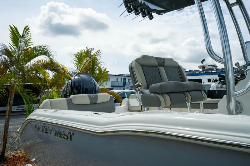 Slide: The Image of 2026 Key West 239 FS boat with sleek seating and palm trees in the background. - 7
