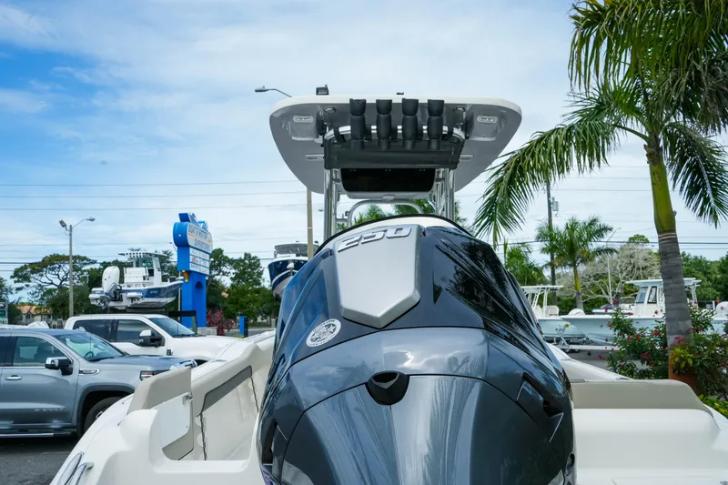 Slide: The Image of 2026 Key West 239 FS boat with powerful engine, parked outdoors under clear sky. - 9
