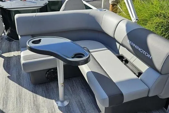 Slide: The Image of 2026 Bennington 22 SF boat interior with gray seating and a small table. - 10